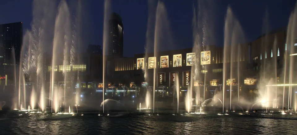 The Dubai Fountain at dusk in front of Dubai Mall