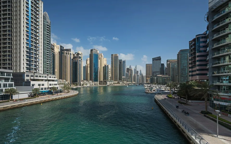 The Dubai Marina promenade with high-rise towers beside the water